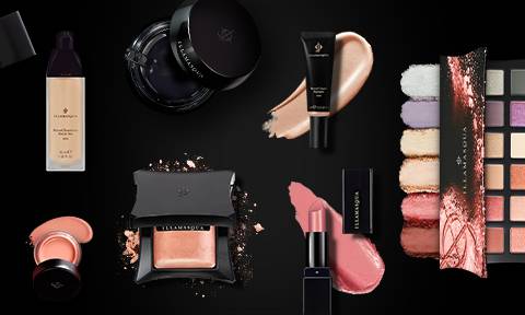 range of Illamasqua vegan makeup on black background including vegan lipstick, primer, eyeshadow palette and foundation
